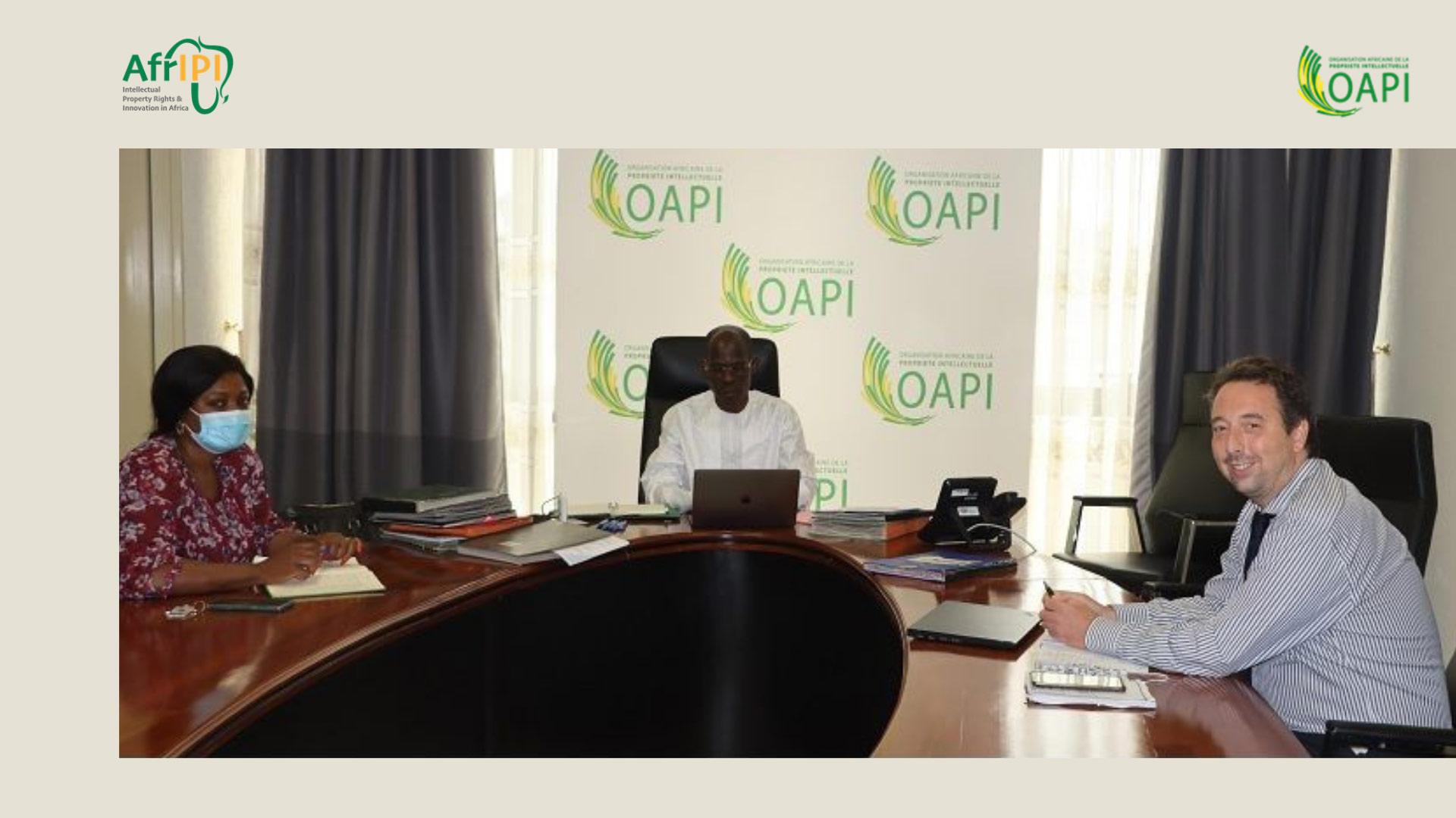 3 persons around the meeting table
